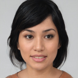 Joyful asian young-adult female with medium  black hair and brown eyes