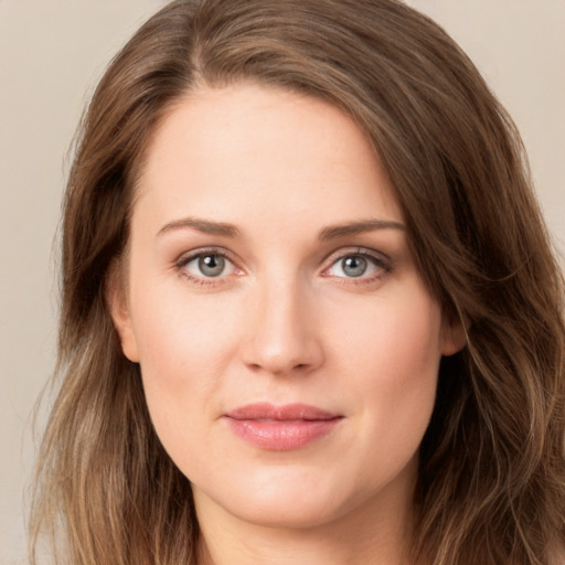 Joyful white young-adult female with long  brown hair and green eyes