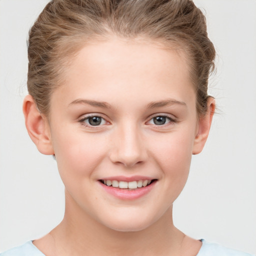 Joyful white child female with short  brown hair and grey eyes