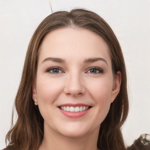 Joyful white young-adult female with long  brown hair and grey eyes