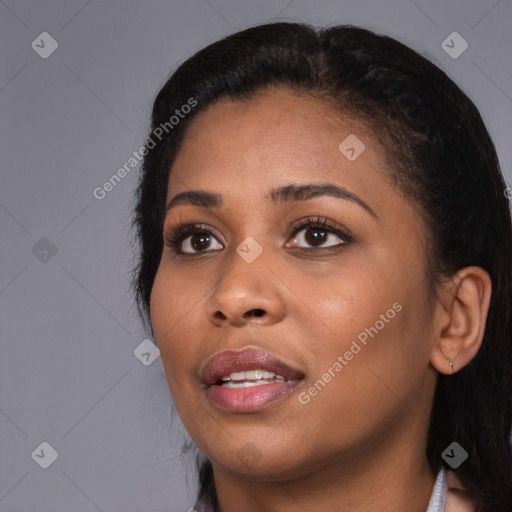 Joyful black young-adult female with long  black hair and brown eyes