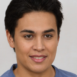 Joyful latino young-adult male with short  brown hair and brown eyes