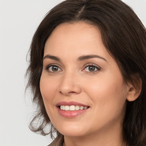 Joyful white young-adult female with medium  brown hair and brown eyes