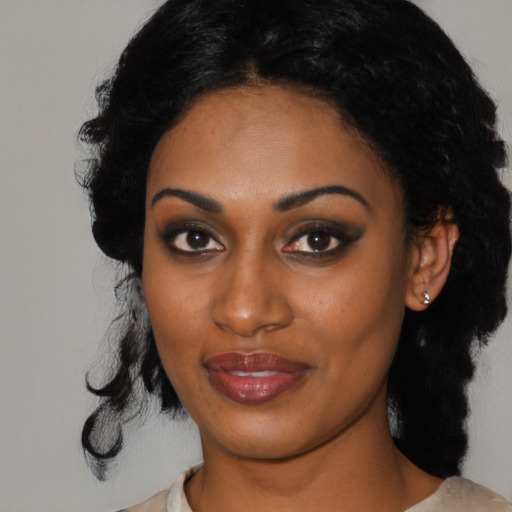 Joyful black young-adult female with medium  black hair and brown eyes