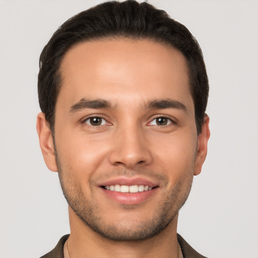 Joyful white young-adult male with short  brown hair and brown eyes