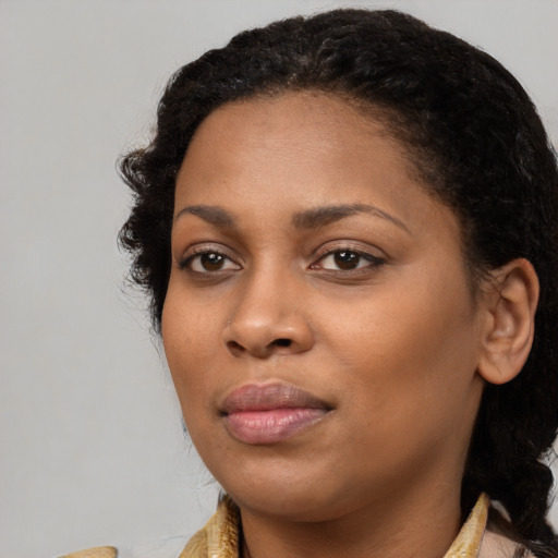 Joyful black young-adult female with medium  brown hair and brown eyes