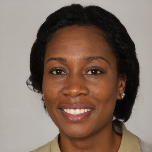 Joyful black adult female with medium  black hair and brown eyes