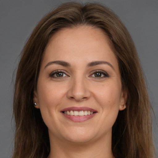 Joyful white young-adult female with long  brown hair and brown eyes