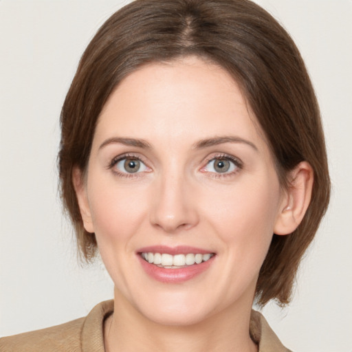 Joyful white young-adult female with medium  brown hair and green eyes