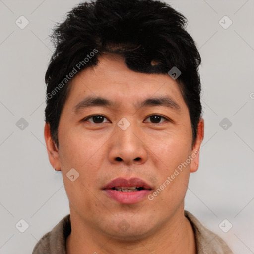 Joyful asian young-adult male with short  black hair and brown eyes