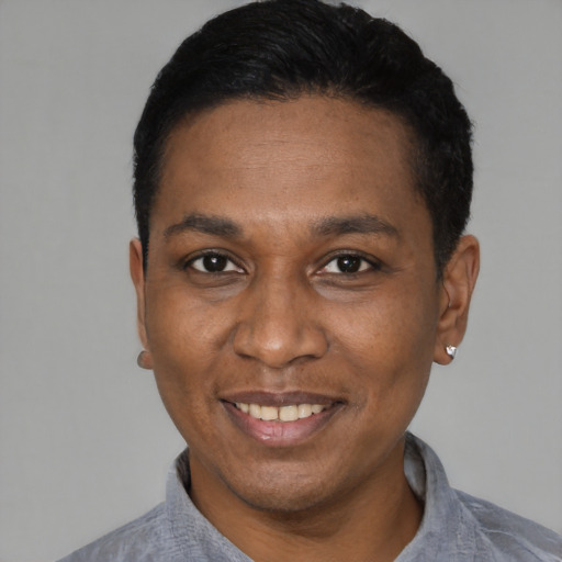 Joyful black young-adult male with short  black hair and brown eyes
