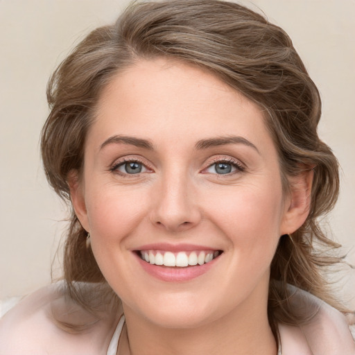 Joyful white young-adult female with medium  brown hair and blue eyes