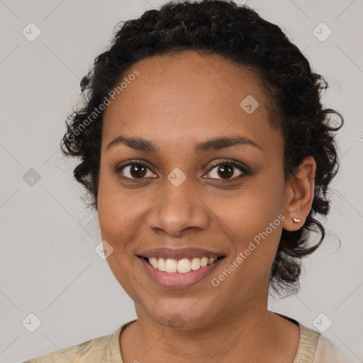 Joyful black young-adult female with medium  brown hair and brown eyes