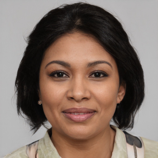 Joyful latino young-adult female with medium  black hair and brown eyes