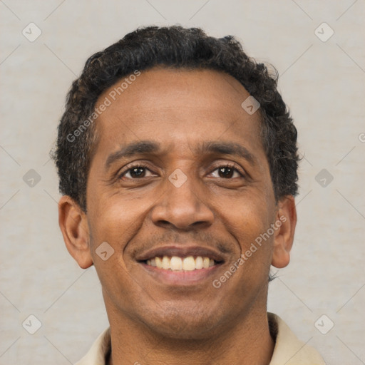 Joyful latino adult male with short  brown hair and brown eyes