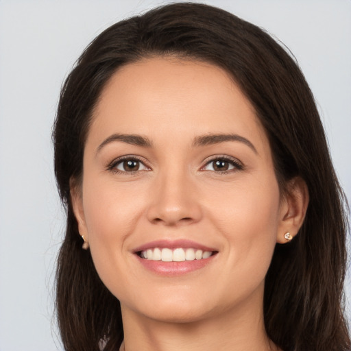 Joyful white young-adult female with long  brown hair and brown eyes