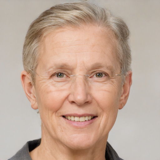 Joyful white middle-aged female with short  gray hair and grey eyes