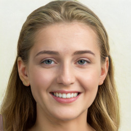 Joyful white young-adult female with long  brown hair and blue eyes