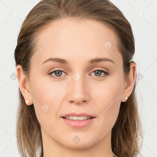 Joyful white young-adult female with long  brown hair and blue eyes