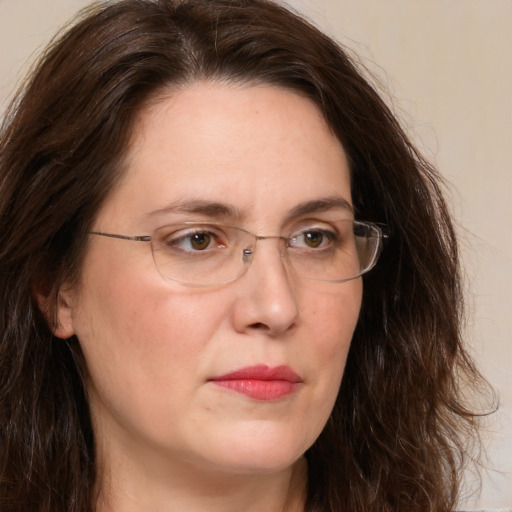 Joyful white adult female with long  brown hair and brown eyes