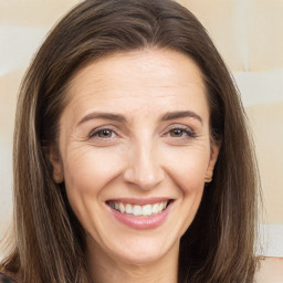 Joyful white adult female with long  brown hair and brown eyes