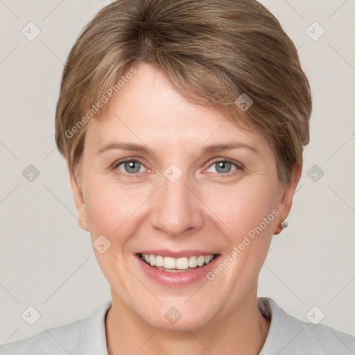 Joyful white young-adult female with short  brown hair and grey eyes