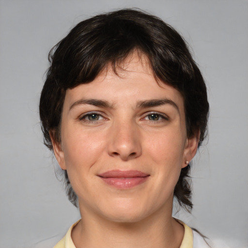 Joyful white young-adult female with medium  brown hair and brown eyes