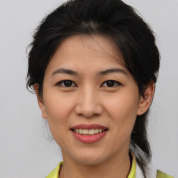 Joyful asian young-adult female with medium  brown hair and brown eyes