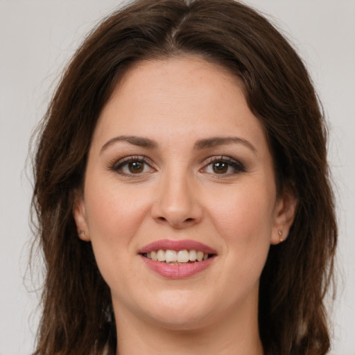 Joyful white young-adult female with long  brown hair and brown eyes