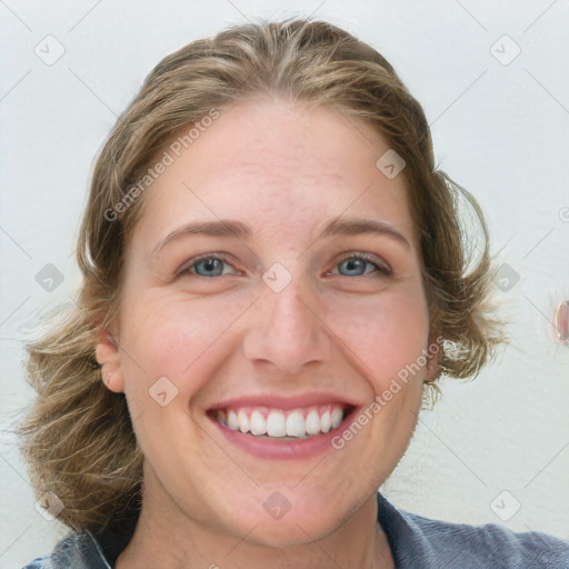 Joyful white young-adult female with medium  brown hair and blue eyes