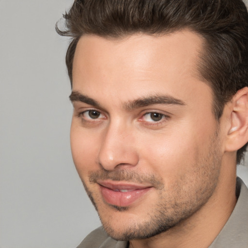 Joyful white young-adult male with short  brown hair and brown eyes