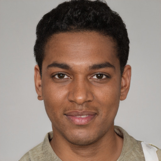 Joyful black young-adult male with short  black hair and brown eyes