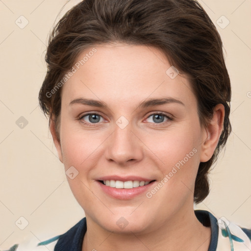 Joyful white young-adult female with medium  brown hair and grey eyes