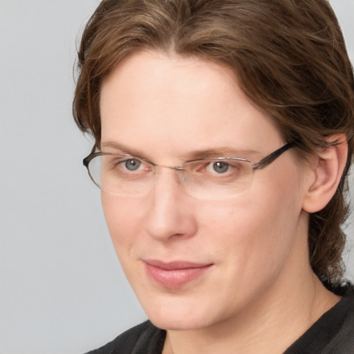 Joyful white adult female with medium  brown hair and grey eyes