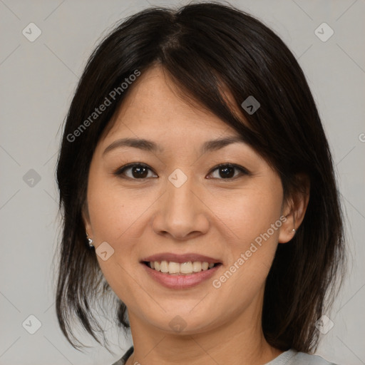 Joyful asian young-adult female with medium  brown hair and brown eyes