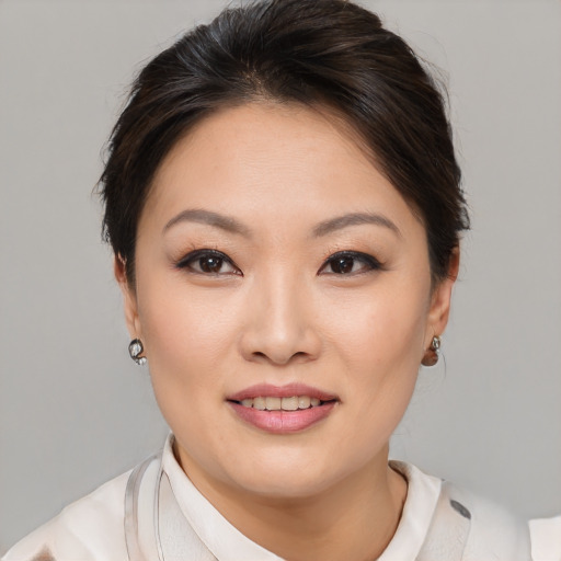 Joyful asian young-adult female with medium  brown hair and brown eyes