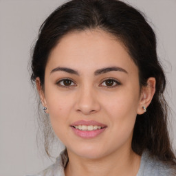 Joyful latino young-adult female with medium  brown hair and brown eyes