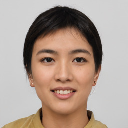 Joyful asian young-adult female with short  brown hair and brown eyes