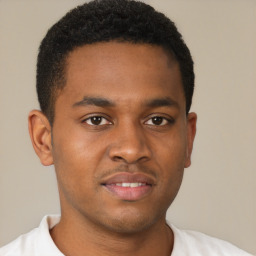 Joyful black young-adult male with short  brown hair and brown eyes