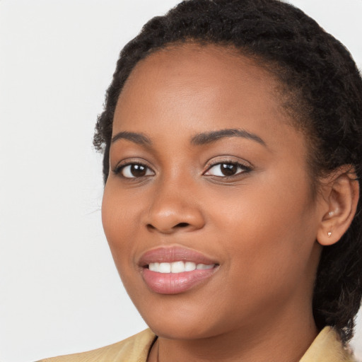 Joyful black young-adult female with long  brown hair and brown eyes