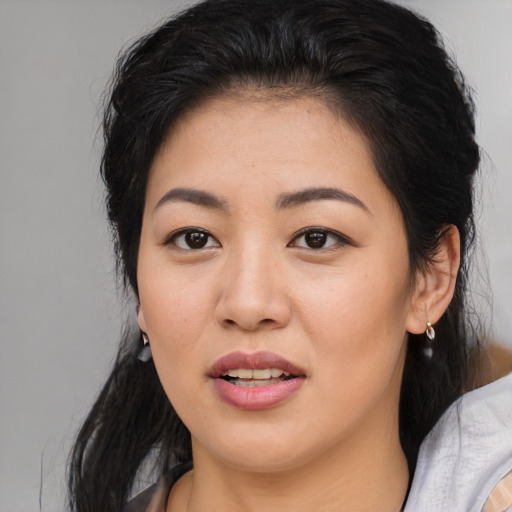 Joyful asian young-adult female with medium  brown hair and brown eyes