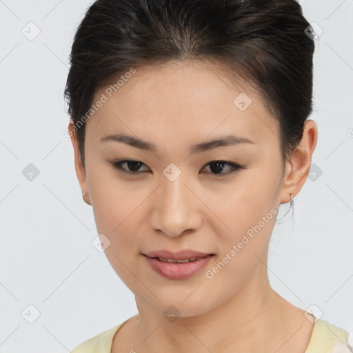 Joyful asian young-adult female with short  brown hair and brown eyes