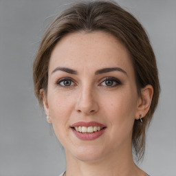 Joyful white young-adult female with medium  brown hair and grey eyes