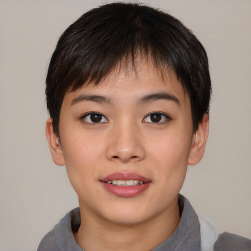 Joyful asian young-adult female with short  brown hair and brown eyes