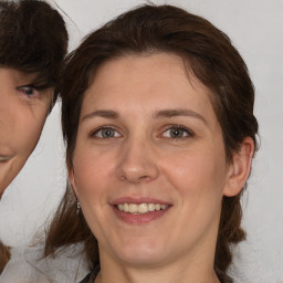 Joyful white adult female with medium  brown hair and brown eyes