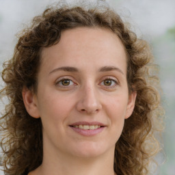 Joyful white young-adult female with medium  brown hair and green eyes