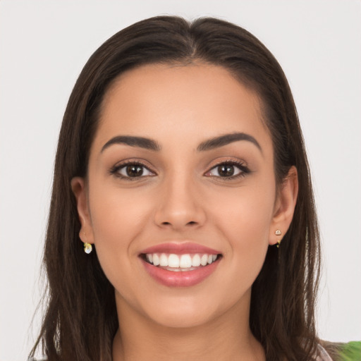 Joyful white young-adult female with long  brown hair and brown eyes