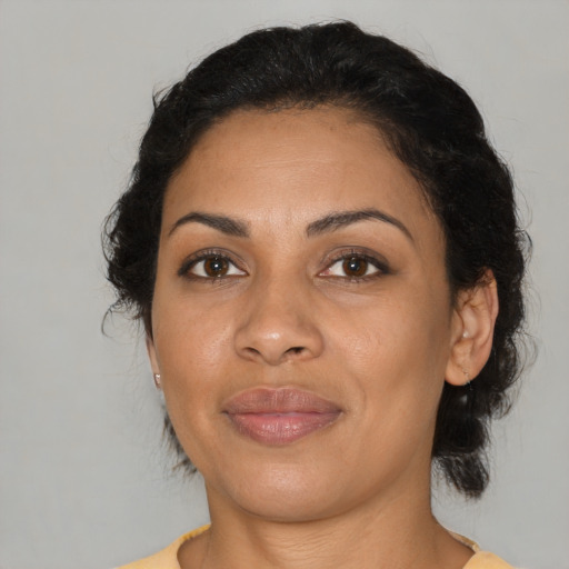 Joyful latino adult female with medium  brown hair and brown eyes
