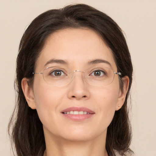 Joyful white young-adult female with medium  brown hair and grey eyes