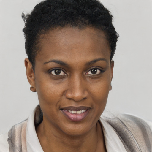Joyful black young-adult female with short  black hair and brown eyes